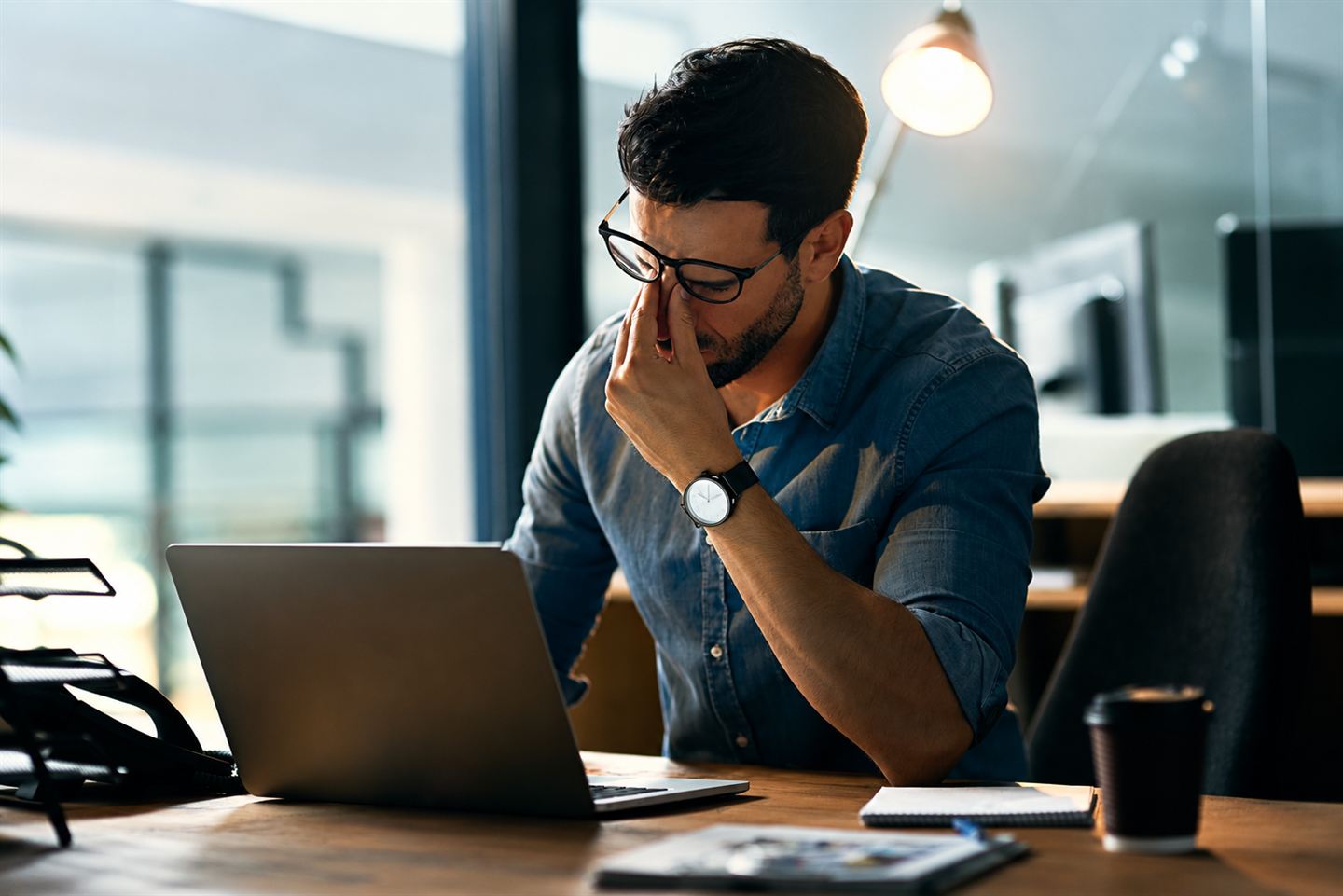 A worried man holding his head, illustrating costly mistakes.